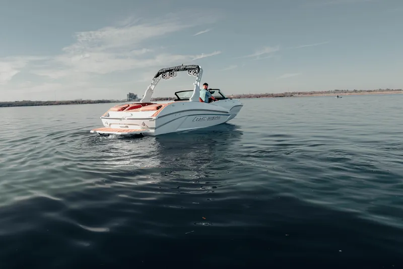 Slide: The Image of 2026 MB B52 23 Alpha boat cruising on calm water under clear sky. - 10