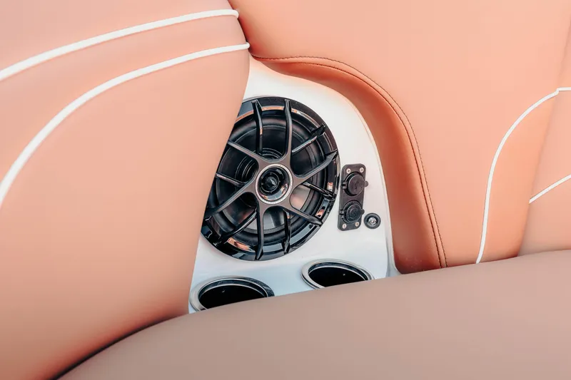 Slide: The Image of 2026 MB B52 23 Alpha boat interior with speaker and tan upholstery. - 13
