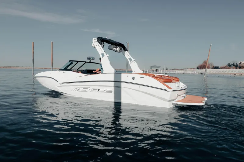 Slide: The Image of 2026 MB B52 23 Alpha boat on calm water, showcasing sleek design and modern features. - 8