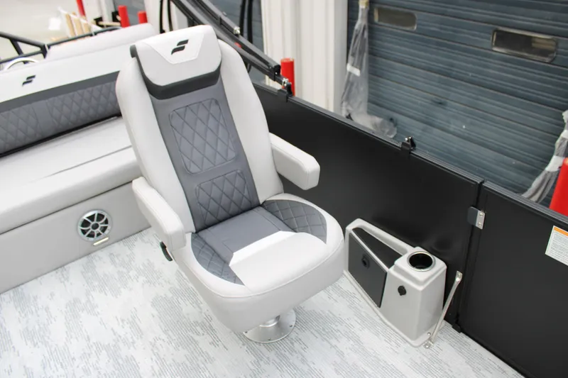 Slide: The Image of 2026 Starcraft SLS 3 Q DH boat interior with gray captain's chair and cup holder. - 7