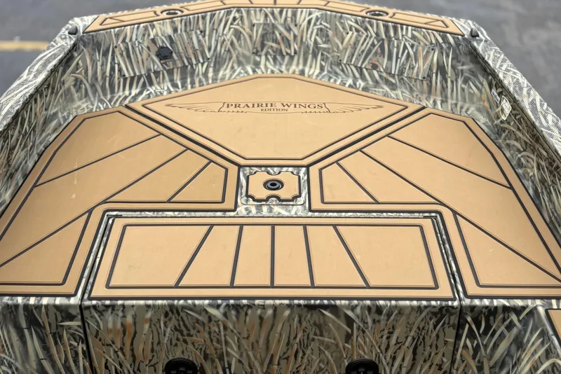 Slide: The Image of 2026 Tracker Grizzly 1650 T Prairie Wings Edition boat with camouflage design and detailed deck. - 10