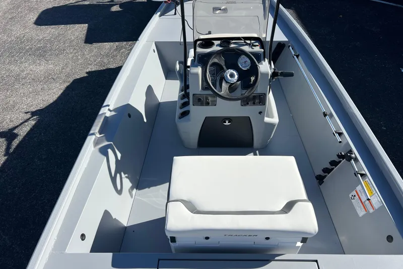 Slide: The Image of 2026 Tracker Bass Tracker Classic CC boat interior with steering console and seating. - 55