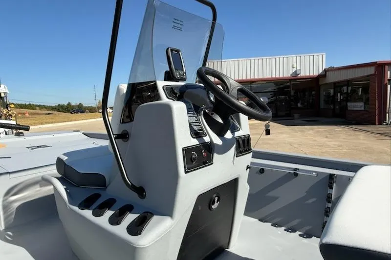Slide: The Image of 2026 Tracker Bass Tracker Classic CC boat console with steering wheel and controls. - 2
