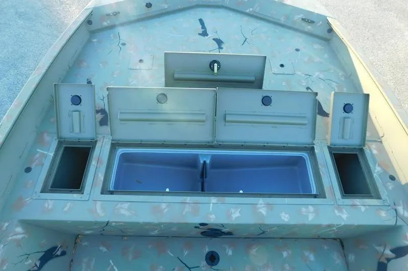 Slide: The Image of 2024 Tracker Grizzly 2072 CC boat interior with storage compartments open. - 13