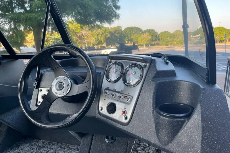 Slide: The Image of Interior view of 2026 Tracker Pro Guide V-16 WT boat dashboard with steering wheel and gauges. - 3