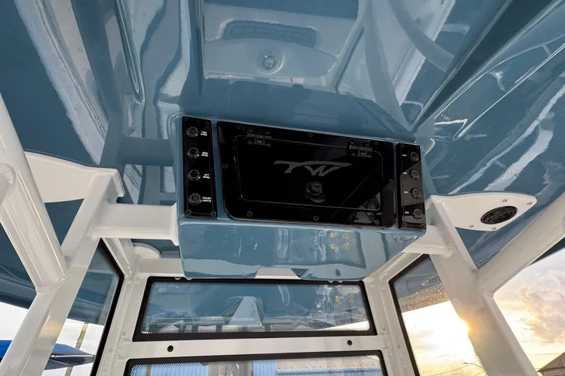 Slide: The Image of 2026 Tidewater 198 CC Adventure boat interior with blue ceiling and control panel. - 10