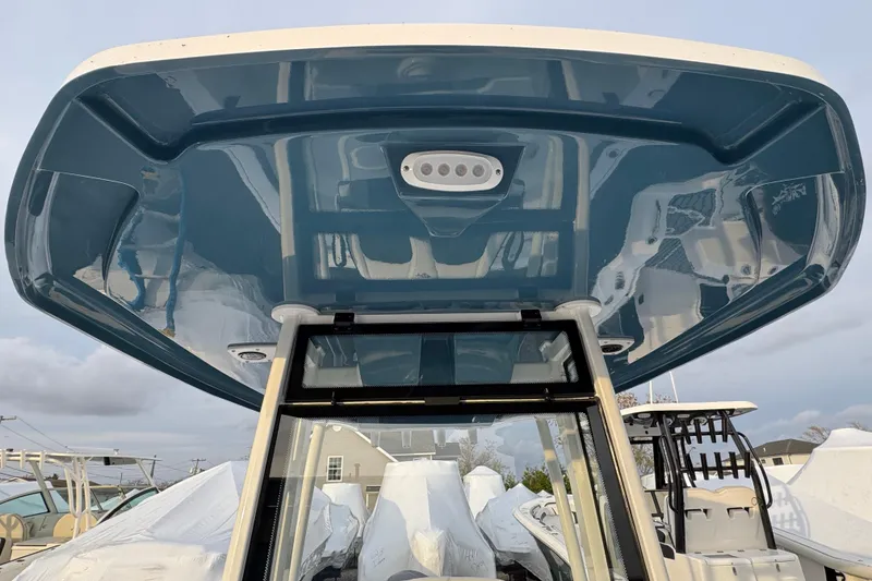 Slide: The Image of 2026 Tidewater 198 CC Adventure boat with sleek blue T-top design. - 13