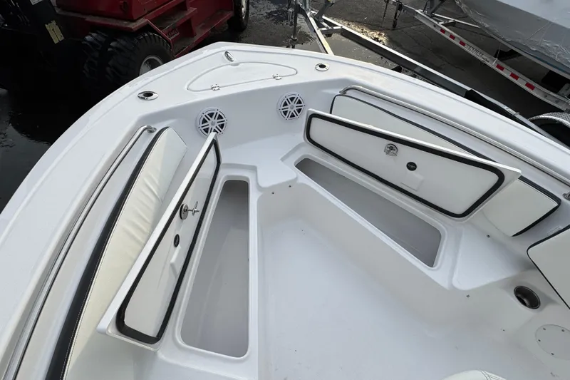 Slide: The Image of 2026 Tidewater 198 CC Adventure boat interior with open storage compartments and speakers. - 18