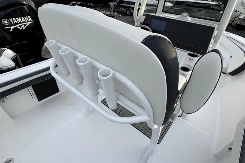 Slide: The Image of 2026 Tidewater 198 CC Adventure boat interior with rod holders and Yamaha engine. - 2