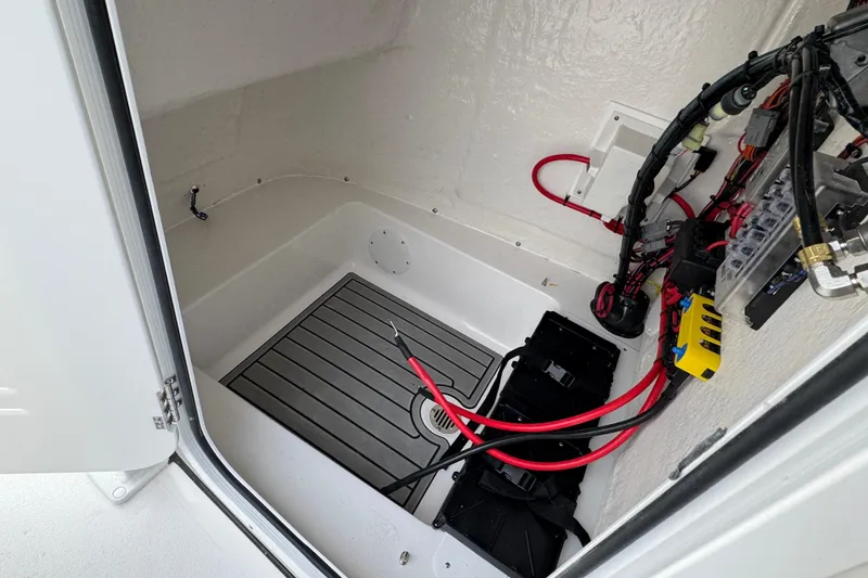 Slide: The Image of 2026 Tidewater 198 CC Adventure boat interior wiring and storage compartment. - 20