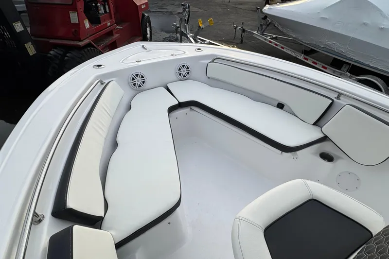 Slide: The Image of 2026 Tidewater 198 CC Adventure boat with white cushioned seating and speakers. - 21