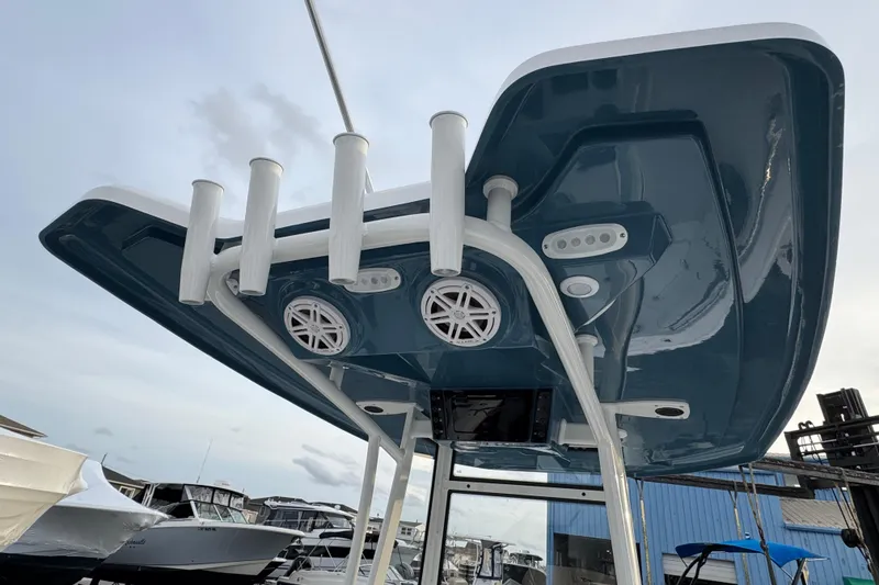 Slide: The Image of 2026 Tidewater 198 CC Adventure boat with rod holders and speakers on the T-top. - 3