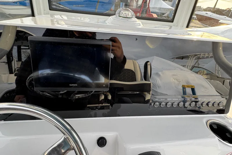 Slide: The Image of 2026 Tidewater 198 CC Adventure boat dashboard with Garmin display and control panel. - 7