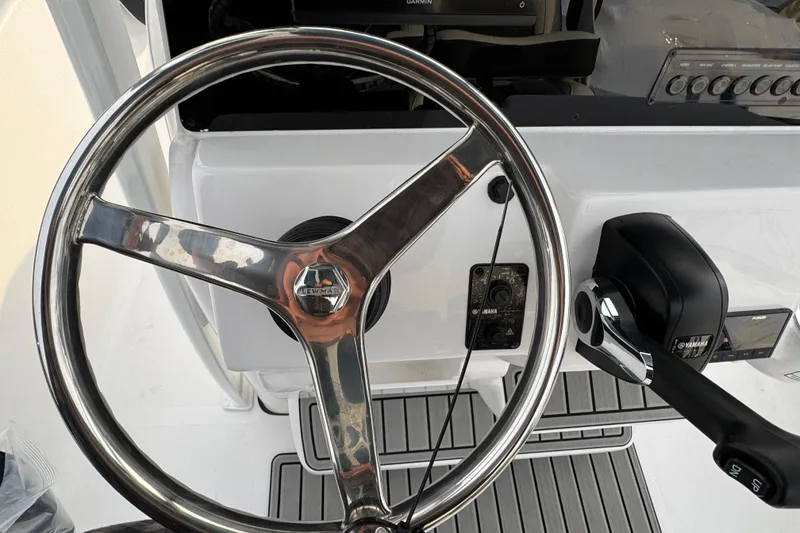 Slide: The Image of Steering wheel and controls of 2026 Tidewater 198 CC Adventure boat. - 8