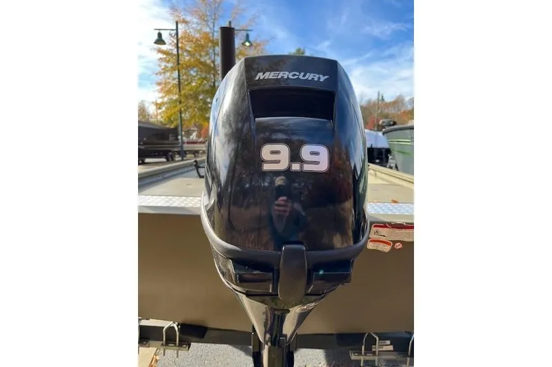 Slide: The Image of Mercury 9.9 outboard motor on 2022 Tracker Grizzly 1648 AWL boat, outdoors. - 3