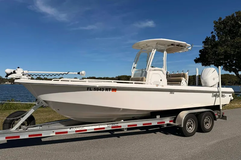 The Image of 2019 Everglades 243 Center Console boat on trailer by a lake. - 0
