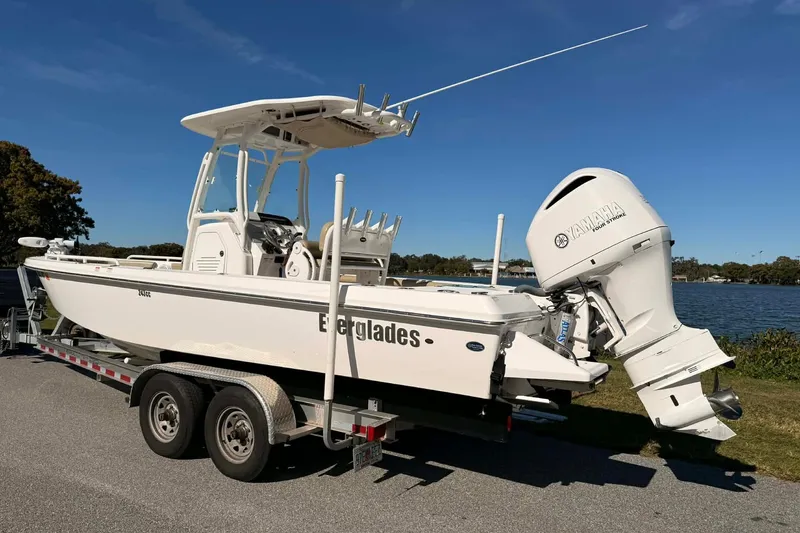 Slide: The Image of 2019 Everglades 243 Center Console boat on trailer, featuring Yamaha outboard motor. - 2