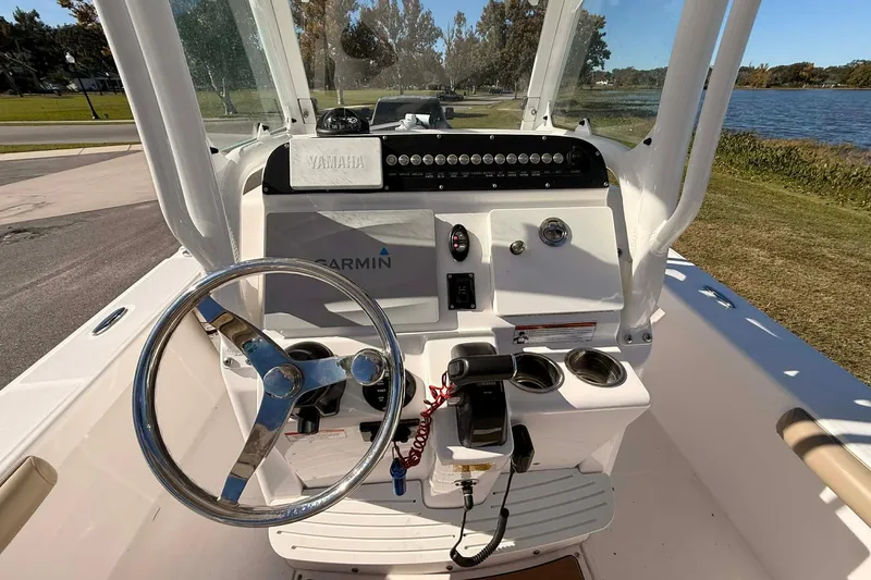 Slide: The Image of 2019 Everglades 243 Center Console boat dashboard with steering wheel and Garmin navigation system. - 6