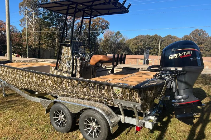 Slide: The Image of 2026 Avid 20 ROGUE CC boat with camouflage design on a trailer, featuring a Yamaha engine. - 4