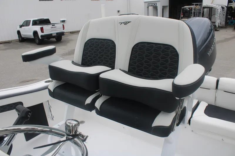 Slide: The Image of 2026 Tidewater 210 LXF boat seats with black and white upholstery, steering wheel visible. - 14