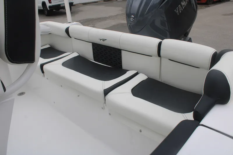 Slide: The Image of 2026 Tidewater 210 LXF boat interior with white and black seating, Yamaha engine visible. - 15