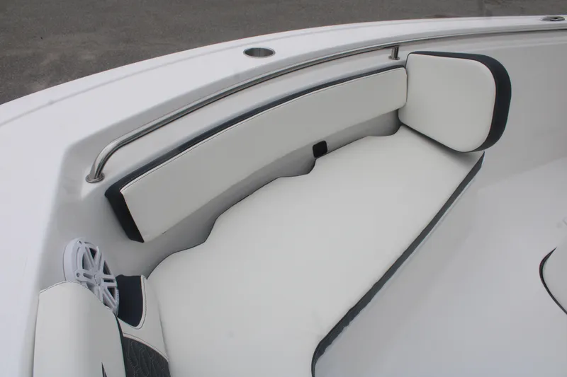 Slide: The Image of 2026 Tidewater 210 LXF boat interior with white cushioned seating and stainless steel railing. - 17