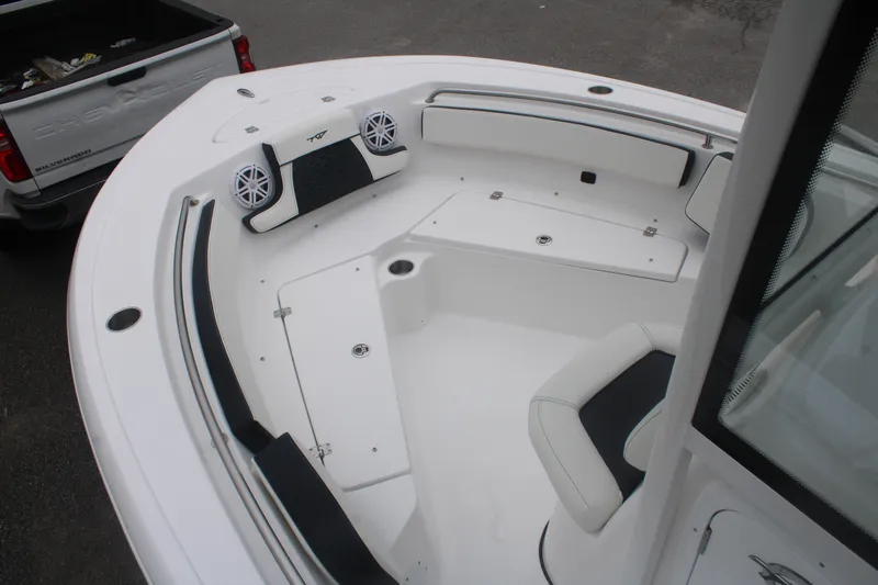 Slide: The Image of 2026 Tidewater 210 LXF boat interior with seating and storage compartments. - 2