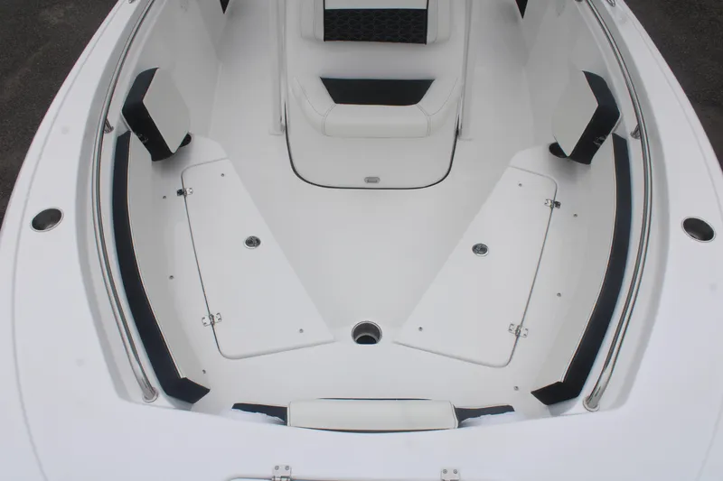 Slide: The Image of 2026 Tidewater 210 LXF boat interior with white seating and storage compartments. - 4
