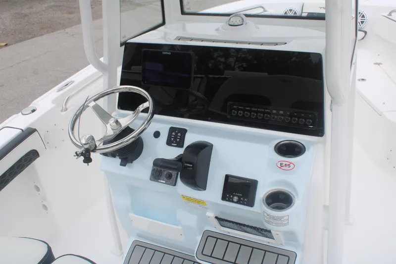 Slide: The Image of 2026 Tidewater 210 LXF boat console with steering wheel and navigation controls. - 7