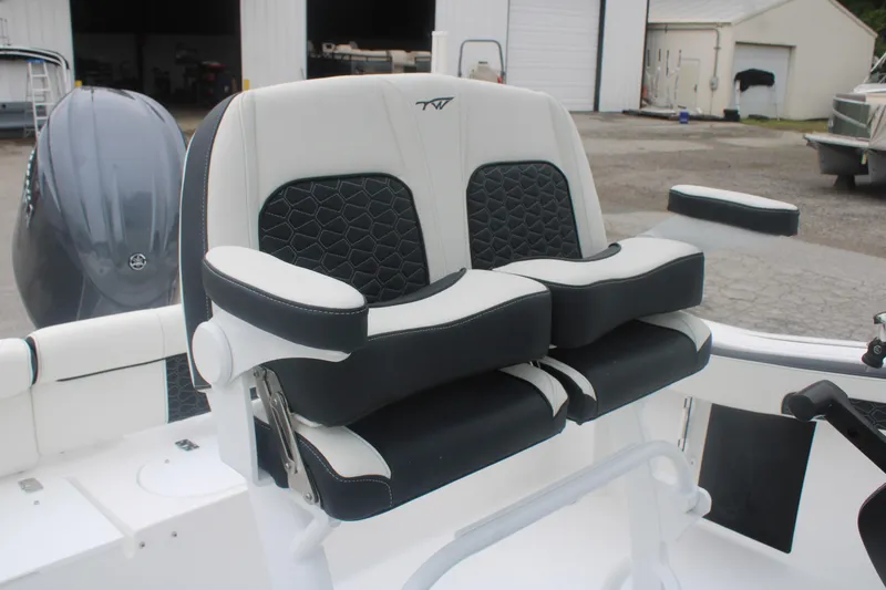 Slide: The Image of 2026 Tidewater 210 LXF boat seating with black and white cushioned design. - 8