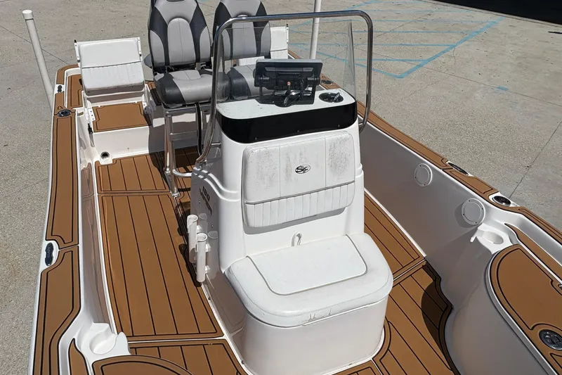 Slide: The Image of 2014 Seafox 180 Viper boat interior with seating and console, featuring brown and white design. - 10