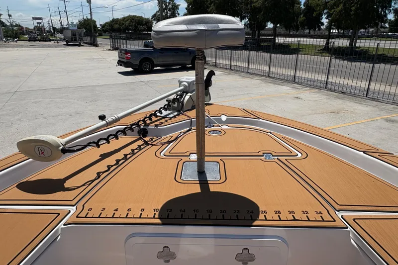 Slide: The Image of 2014 Seafox 180 Viper boat deck with trolling motor and seat in parking lot. - 12