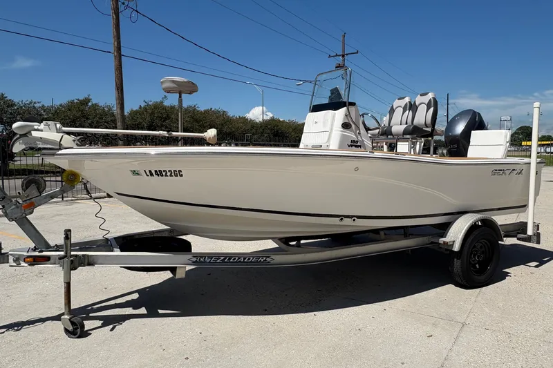 Slide: The Image of 2014 Seafox 180 Viper boat on trailer, parked outdoors under clear blue sky. - 3