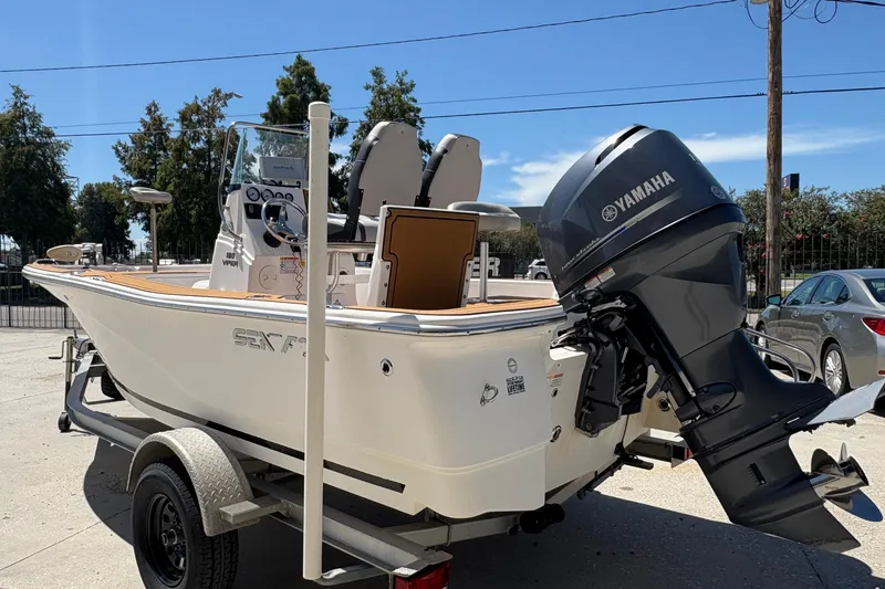 Slide: The Image of 2014 Seafox 180 Viper boat with Yamaha outboard motor on trailer, parked outdoors. - 4