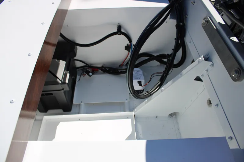Slide: The Image of Interior view of 2026 Starcraft 57 Ski Champ boat showing wiring and battery compartment. - 11