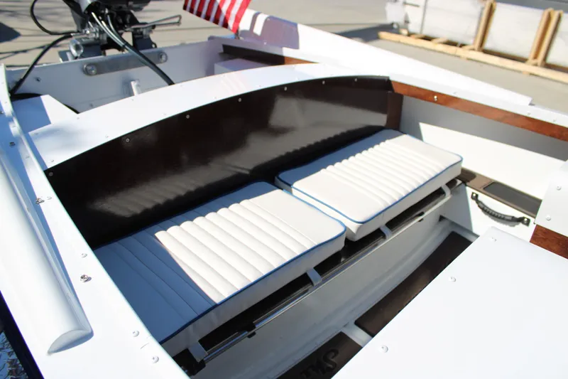 Slide: The Image of Interior of 2026 Starcraft 57 Ski Champ boat with white cushioned seats. - 8