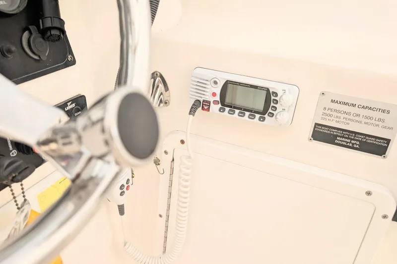 Slide: The Image of 2003 Palm Beach 22 Dual Console boat dashboard with steering wheel and radio controls. - 10