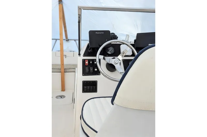 Slide: The Image of 2003 Palm Beach 22 Dual Console boat interior with steering wheel and controls. - 12