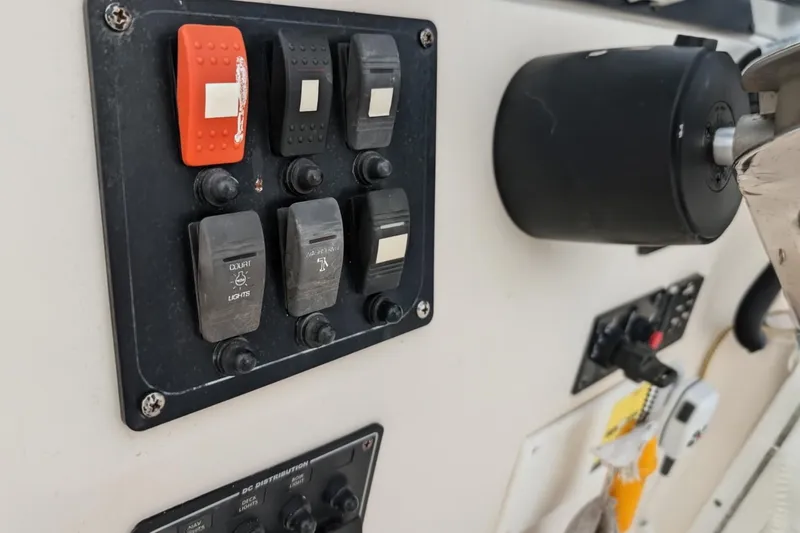 Slide: The Image of Control panel of 2003 Palm Beach 22 Dual Console boat with switches and knobs. - 13