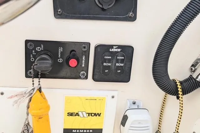 Slide: The Image of Control panel of a 2003 Palm Beach 22 Dual Console boat with Sea Tow membership sticker. - 14