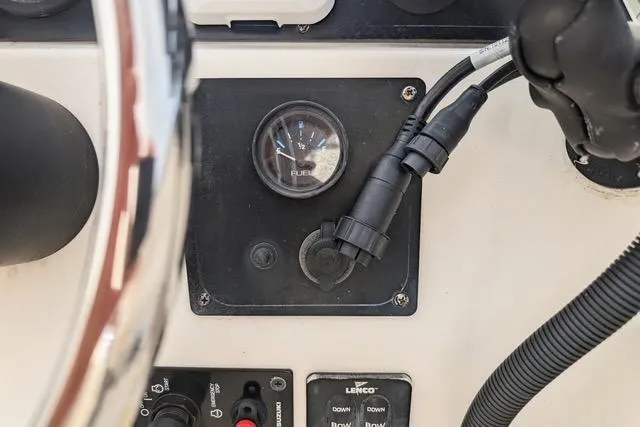 Slide: The Image of Dashboard of 2003 Palm Beach 22 Dual Console boat with fuel gauge and controls. - 15