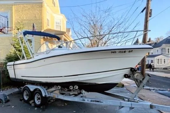 Slide: The Image of 2003 Palm Beach 22 Dual Console boat on trailer, parked in residential area. - 4