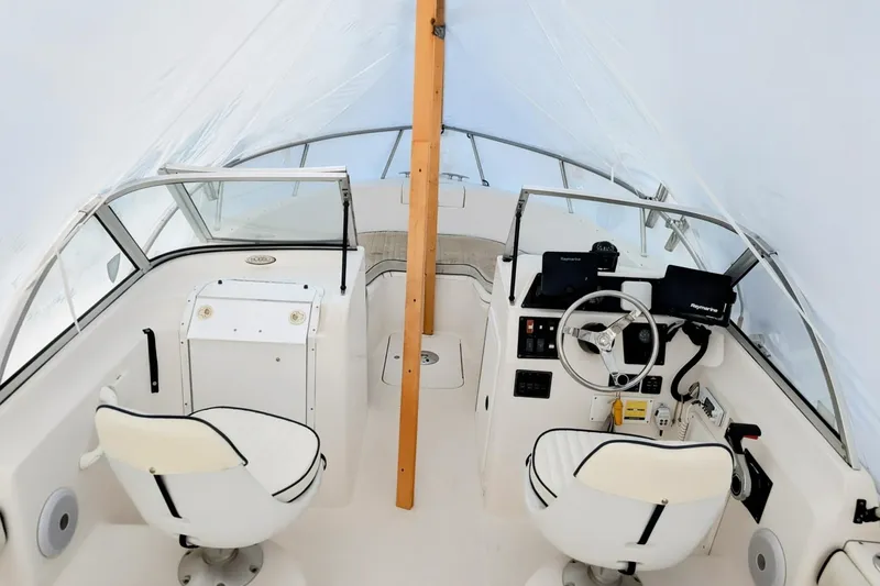 Slide: The Image of 2003 Palm Beach 22 Dual Console boat interior with steering wheel and seating. - 6