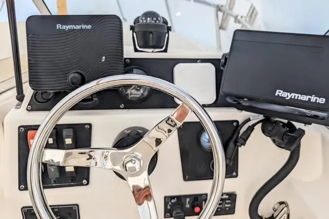 Slide: The Image of 2003 Palm Beach 22 Dual Console boat dashboard with Raymarine navigation equipment. - 9
