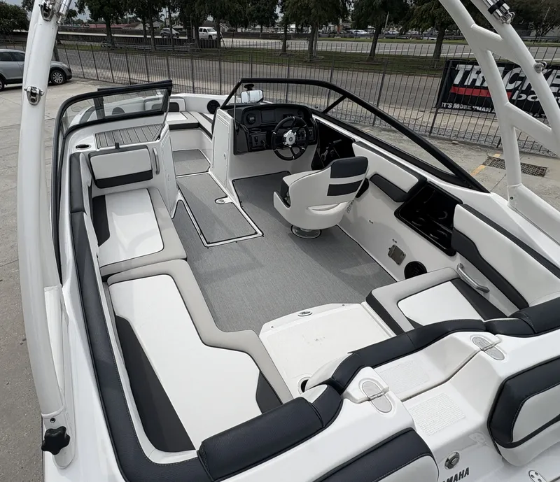 Slide: The Image of 2024 Yamaha Boats AR 195 interior with sleek seating and modern dashboard. - 10