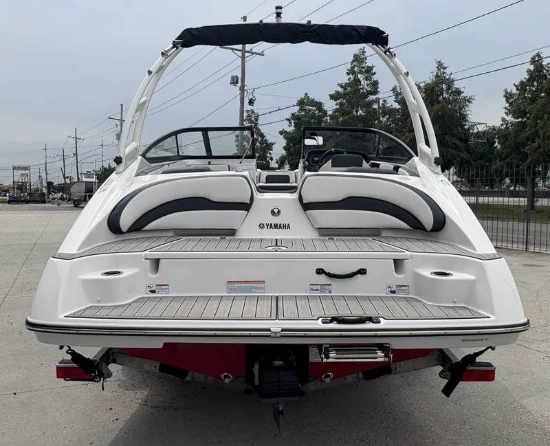 Slide: The Image of 2024 Yamaha Boats AR 195, rear view, showcasing sleek design and spacious seating. - 5