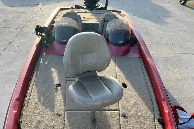 Slide: The Image of 2004 Stratos 201 Pro XL boat interior with seating and carpeted deck. - 12