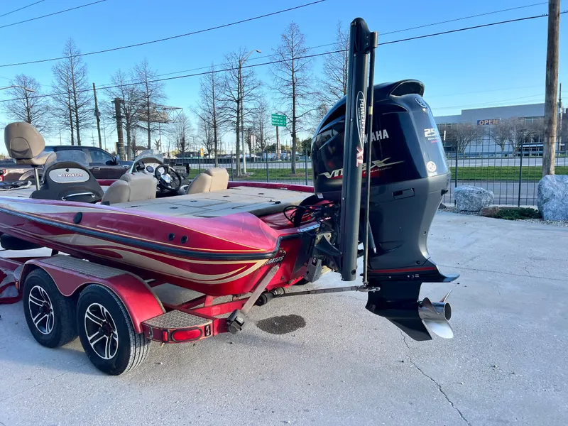 Slide: The Image of 2004 Stratos 201 Pro XL boat with Yamaha VMAX engine, parked on a trailer. - 7