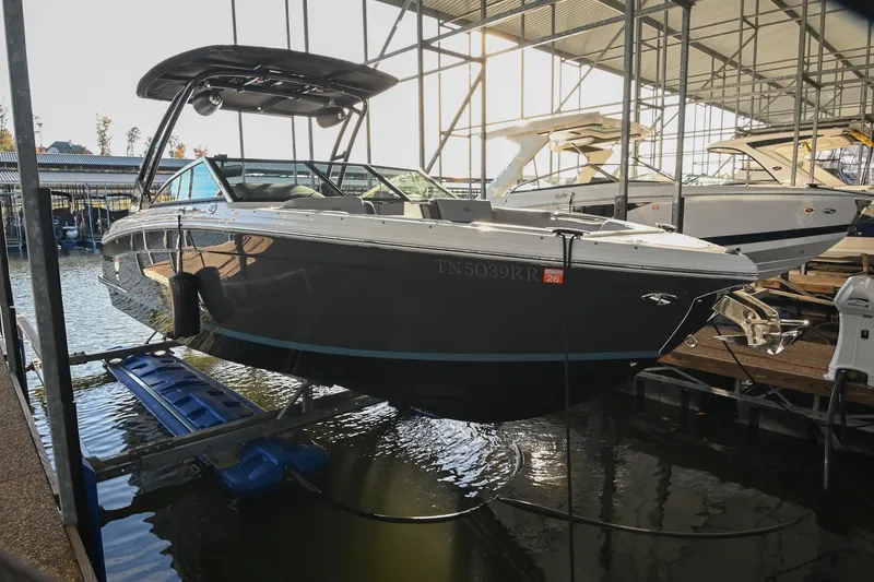The Image of 2024 Cobalt R8 boat docked in a marina, elevated on a lift. - 0