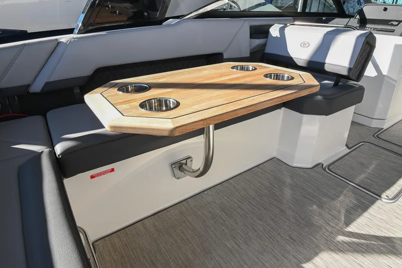 Slide: The Image of Luxurious interior of 2024 Cobalt R8 boat with seating and table, dockside view. - 19